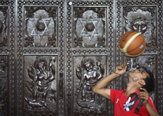 Thaneshwar Guragai ağzında bir diş fırçasıyla 22.41 saniye basketbol topu çeviriyor.