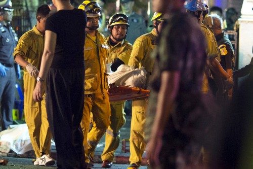 The body of a victim is carried away from the Erawan shrine, the site of a deadly blast in central Bangkok
